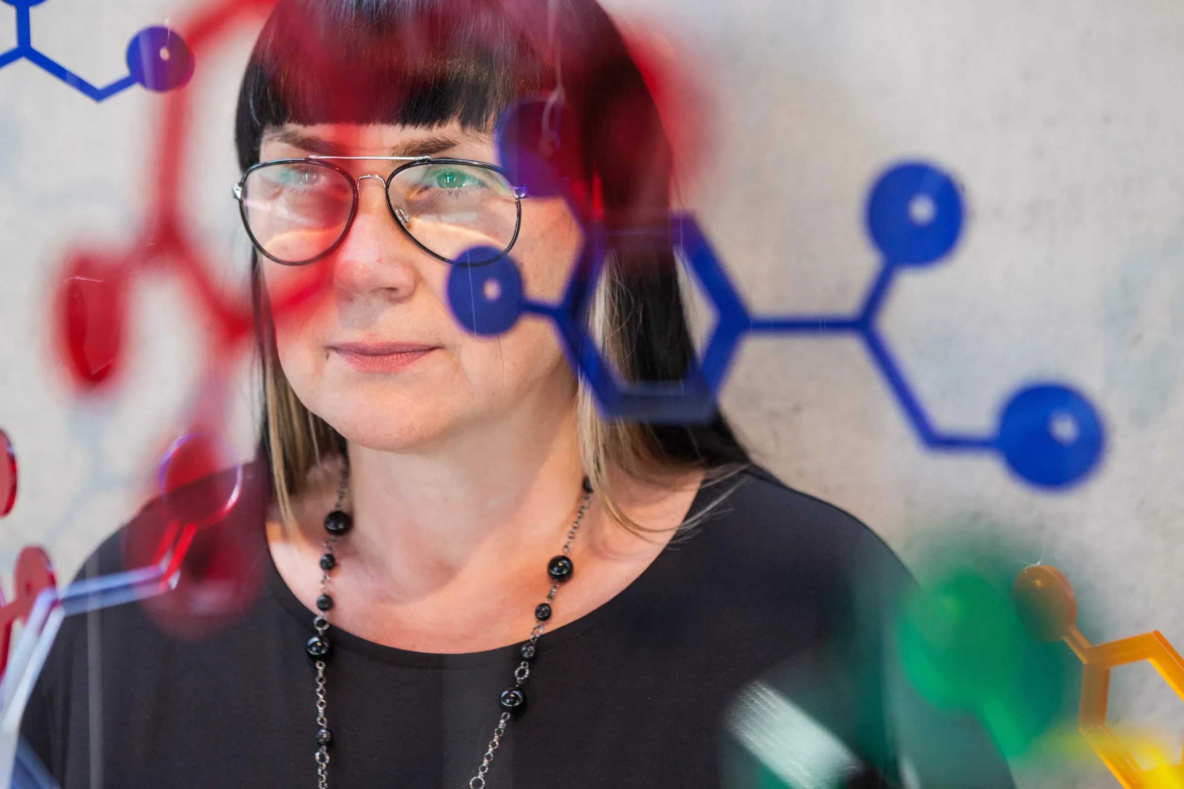 Małgorzata Marczewska na tle graficznego motywu neurobiologii